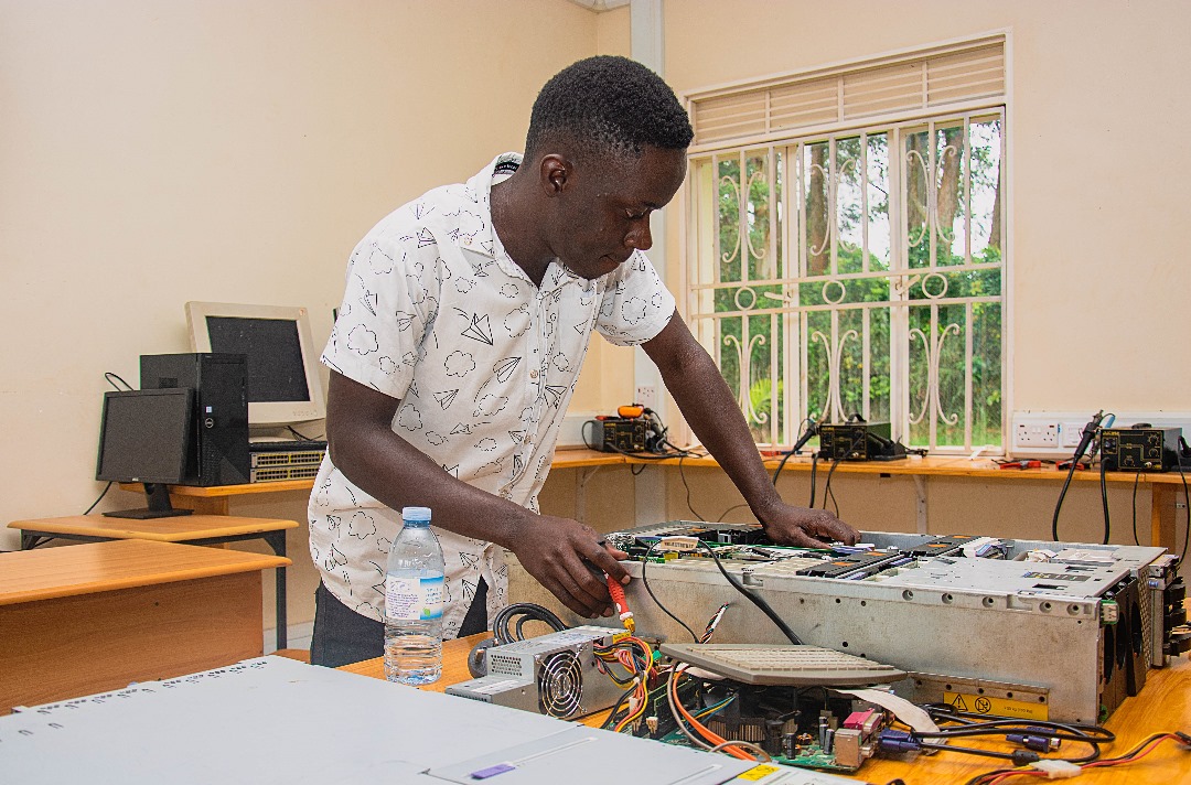 A student learning practical computer hardware repair